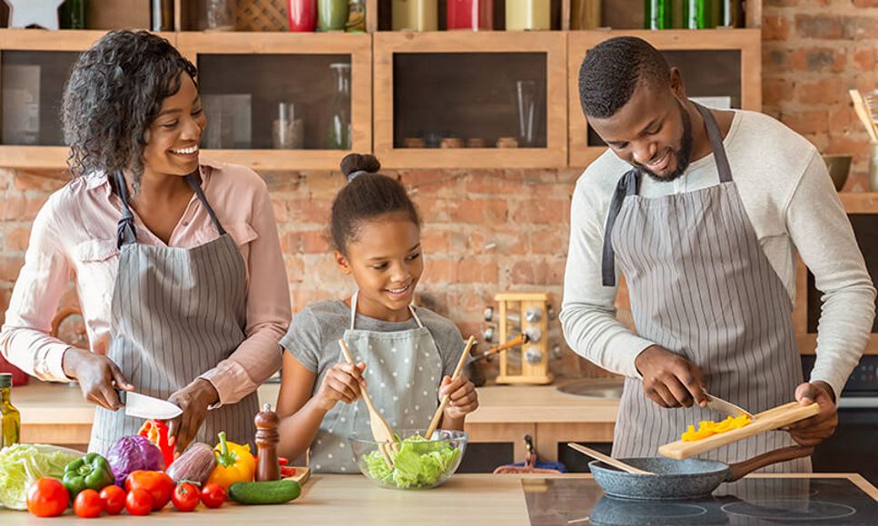 family cooking together in kitchen